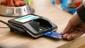 Customer using a Visa linked customer loyalty card to make a purchase