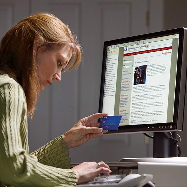A woman doing a secure online payment with her Visa card